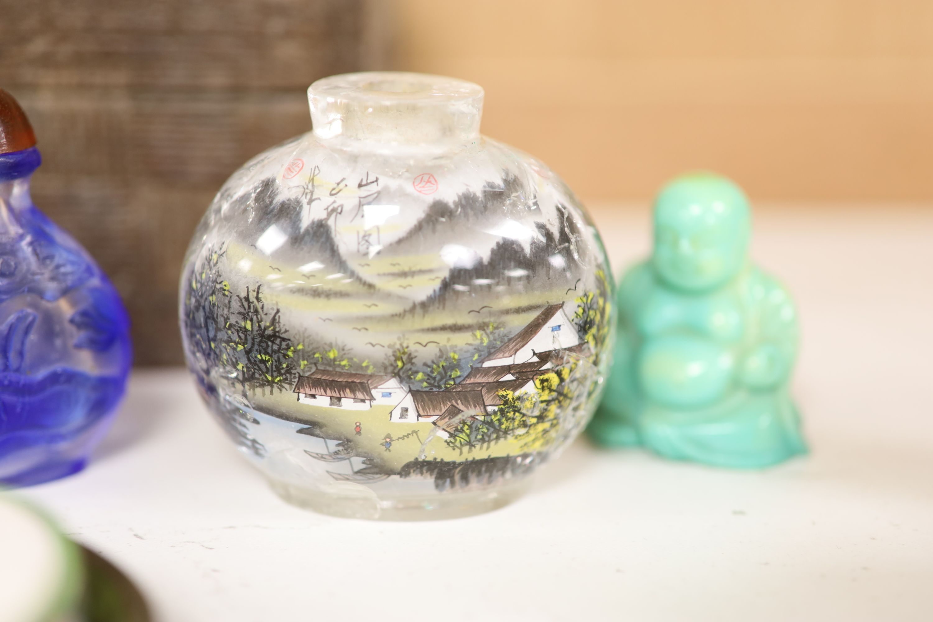 A small miscellaneous Oriental collection including enamel snuff boxes, Buddha carvings etc.